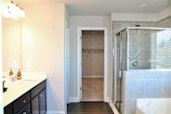 a bathroom with a shower and a sink and a mirror at Herrin Farms, Auburn, 30011