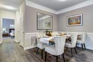 A dining room with a table set for four.