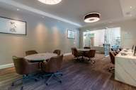 A conference room with a table and chairs.