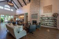 A living room with a fireplace and a large window.