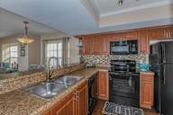 Bloomingdale Woods Apartments Valrico Florida Model Apartment Kitchen with Double Sink, Black Appliances, decorative lighting fixtures