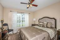 Bloomingdale Woods Apartments Valrico Florida Model Apartment Bedroom with Ceiling Fan, Window, and Furniture