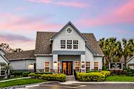Leasing Clubhouse with a front yard and a sign that says Bloomingdale Woods.