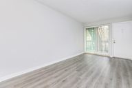 Room with a white door and a window with curtains.