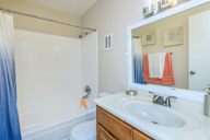 Bathroom with a white sink and a blue shower curtain.