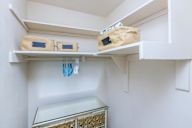 Kitchen with a glass drawer and two bags on the shelf.