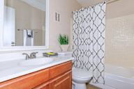 Bathroom with a white sink, toilet, and shower curtain.