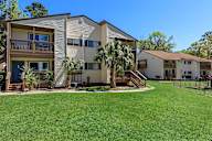 Sunny day at a residential complex with a well-maintained lawn.