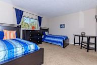 Bedroom with two beds and a dresser.