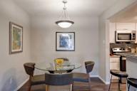 A dining room with a glass table and chairs.