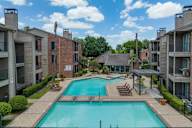 A swimming pool surrounded by apartment buildings.