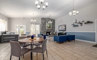 Dining room with a stone fireplace and a wooden table.