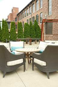 A patio with a table and chairs.