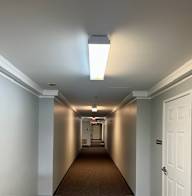 A long hallway with white doors on both sides.