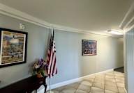 A room with a flag and a painting on the wall.