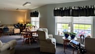 A living room with a dining table and chairs.