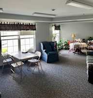 A dining room with a table and chairs.
