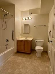 A small bathroom with a toilet, sink, and bathtub.