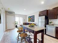 A kitchen with a bar stool and a countertop.