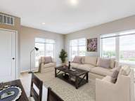 A living room with a couch, chair, and coffee table.