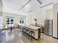 A kitchen with a bar area and stools.