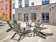 A patio with chairs and a table.