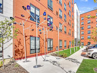 A building with orange walls and a white fence.