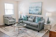 a living room with a couch and two chairs