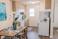 a kitchen and dining room with a table and chairs