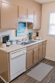 a kitchen with a sink and a dishwasher in it