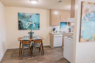 a kitchen and dining area with a table and chairs