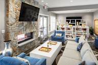 a living room with couches and a coffee table and a fireplace