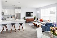 a living room and kitchen in a modern apartment