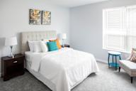 a bedroom with a white bed and colorful pillows