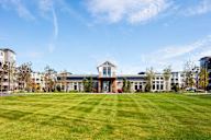 a large building with a lawn in front of it