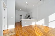 Room with wooden floors and white walls.
