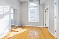 A room with wooden floors and white walls.