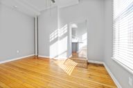 A room with wooden floors and white walls.