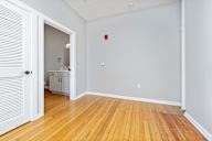 A room with wooden floors and a white door.
