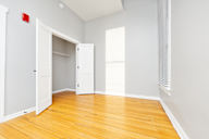 A room with a white door and a red fire alarm.