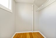 A room with a white wall and a wooden floor.