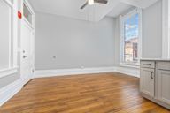 A room with wooden floors and white walls.