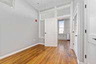 A room with wooden floors and white walls.