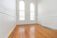 A room with wooden floors and white walls.