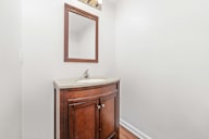 A bathroom with a sink and a mirror.