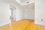 A room with wooden floors and white walls.