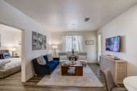 Cozy living room with a couch, chairs, and a coffee table.