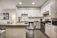 Modern kitchen with a central island, stove, and sink.