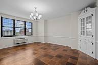 A room with a brown checkered floor and a white door.