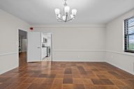 A room with a checkered floor and a chandelier.